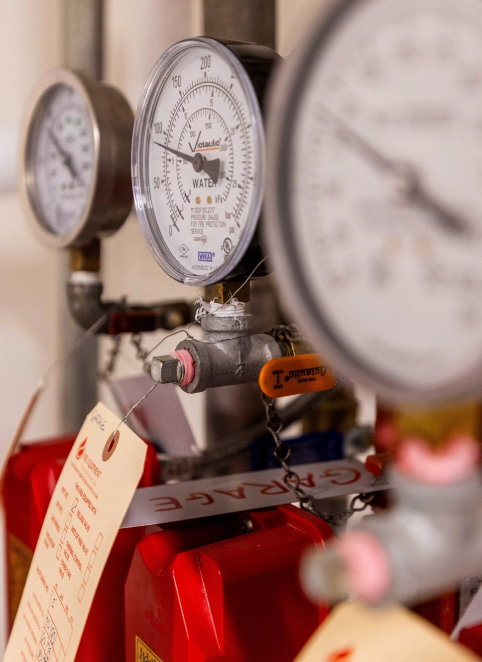 Fire protection system pressure gauges and inspection tags in a residential mechanical room